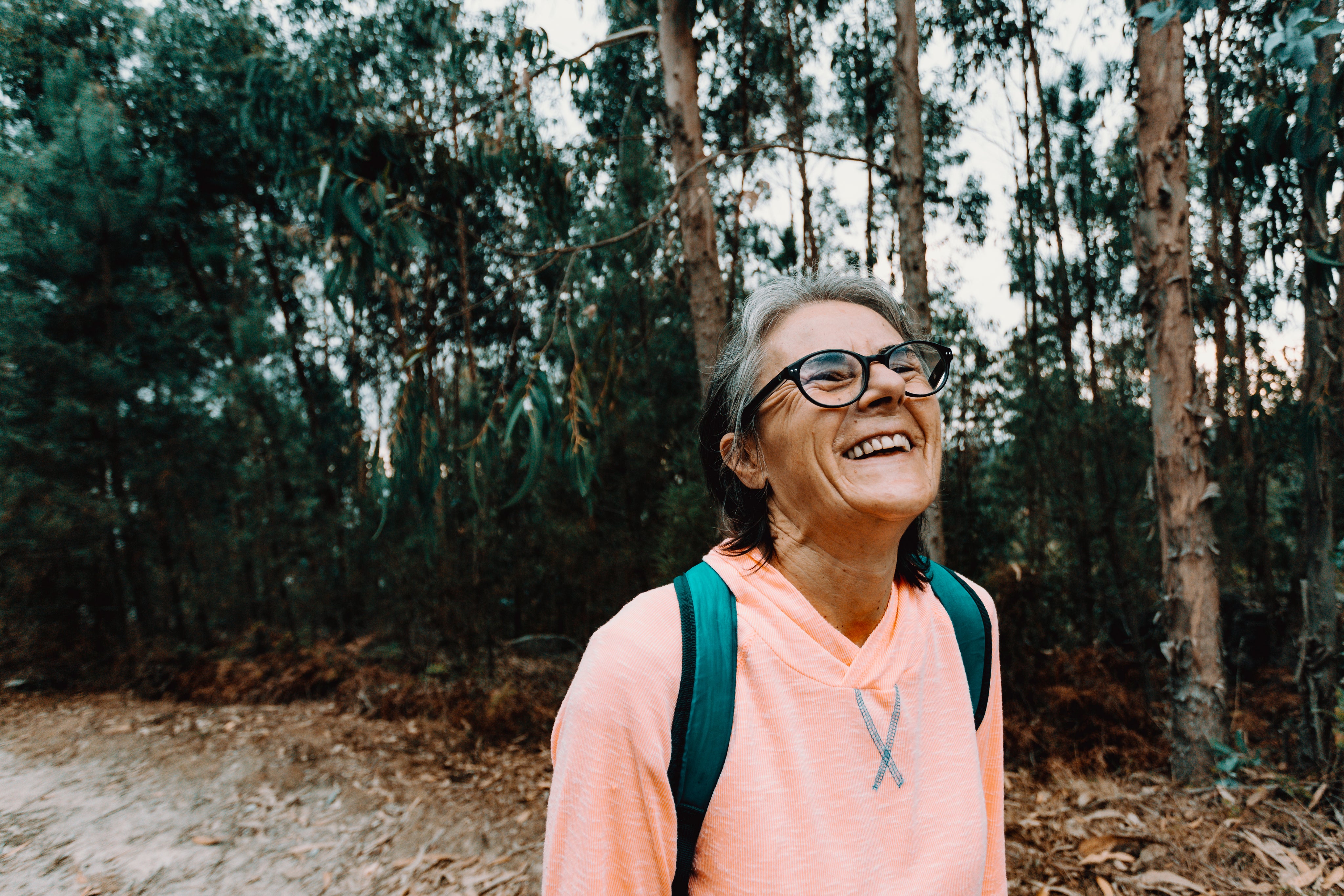 woman-tilts-her-head-back-and-smiles-outdoors.jpg